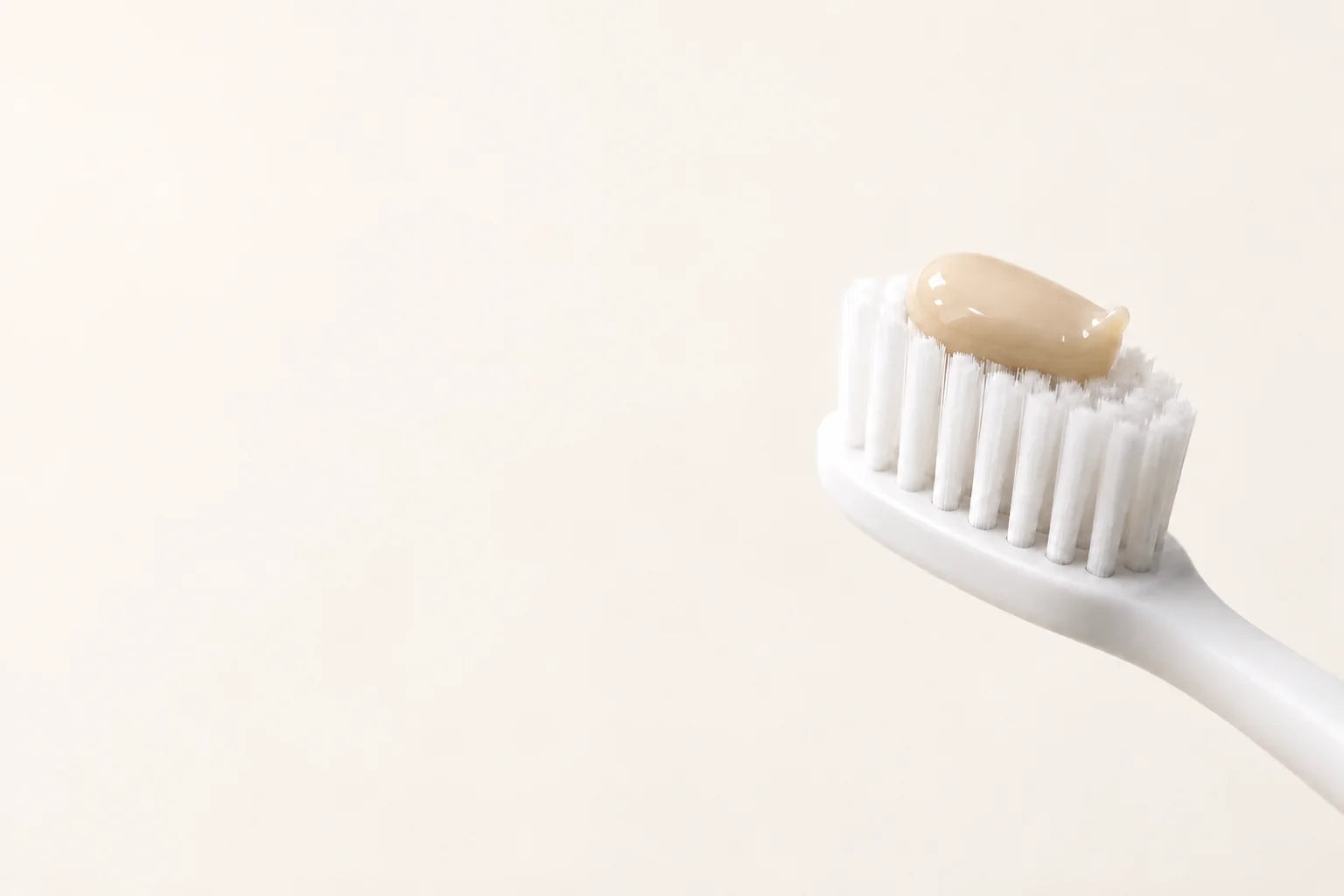 Natural toothpaste texture on a toothbrush.