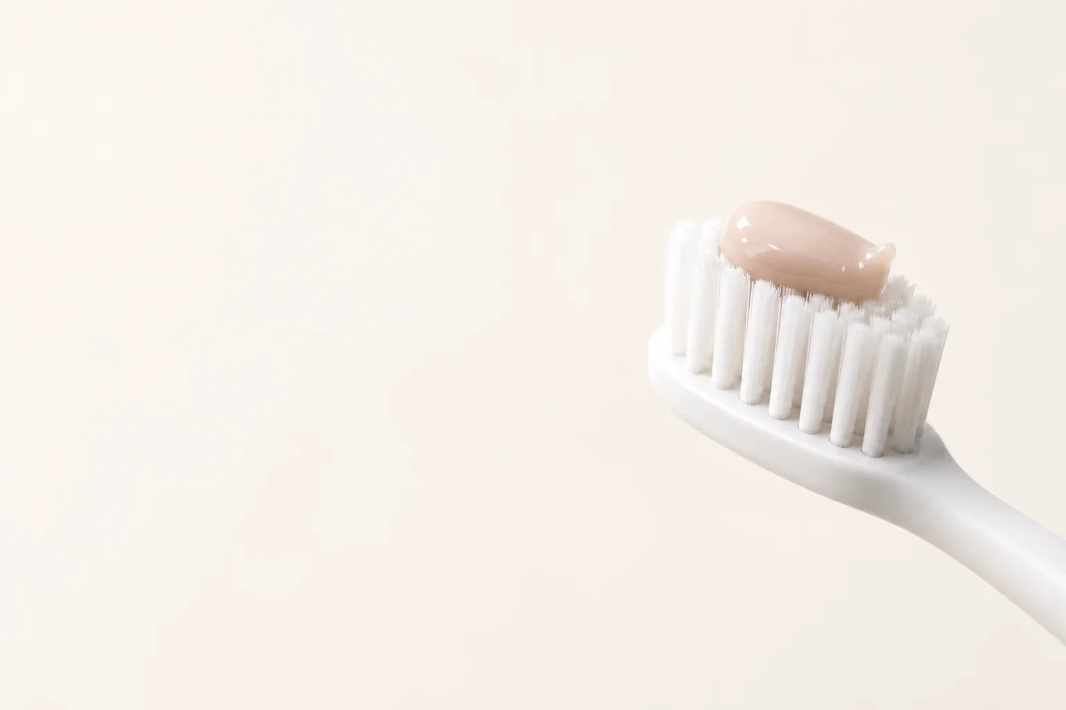 Natural toothpaste texture on a toothbrush.