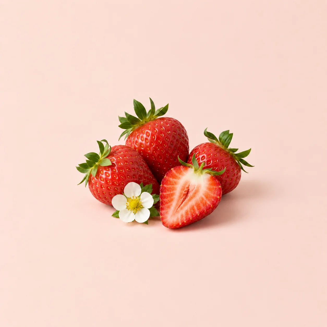 Fresh strawberries against a peach background.